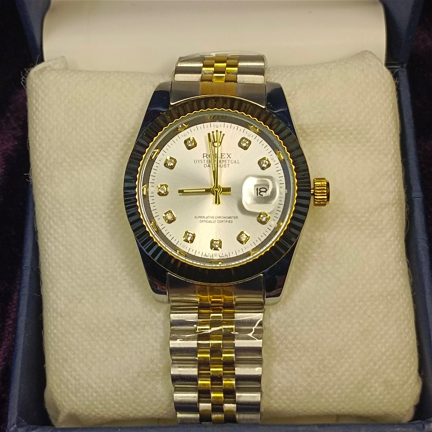 Two tone watch in gold and silver on foam in a blue box. View from above