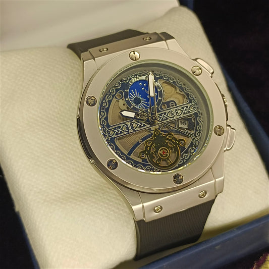 Luxury watch with intricate design on a beige cushion