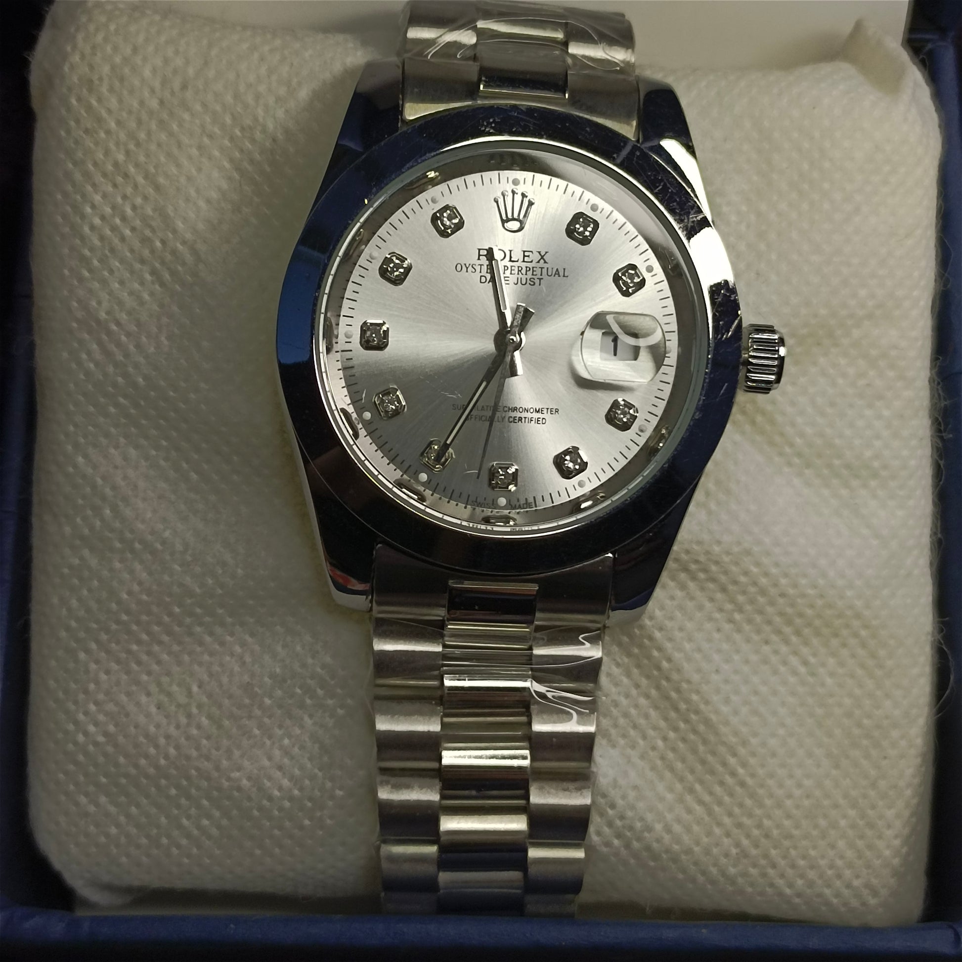 Silver watch on white foam in a blue box